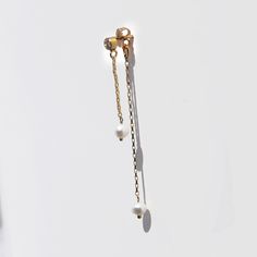 Super chic long tiny freshwater pearl and diamond post earrings feature two lengths of delicate rolo chain: The shorter chain length drops from the front of the earlobe and the longer chain length drops from the back of the earlobe. Chain, diamond ear post and butterfly back are all made of high quality genuine 14k gold filled metal made in the USA.  14k gold filled metal does not flake off and contains significantly more gold than regular 'gold plated' jewelry. It is considered second in qualit Minimalist Long Drop Earrings With Pearl Charm, Everyday 14k Gold Filled Pearl Chain Earrings, Dainty Long Drop Pearl Charm Earrings, Dainty Single Long Drop Pearl Earring, Everyday Long Drop Earrings With Pearl Charm, Minimalist Pearl Chain Earrings In 14k Gold Filled, Minimalist Pearl Chain 14k Gold Filled Earrings, Minimalist 14k Gold Filled Pearl Chain Earrings, Yellow Gold Earrings With Pearl Chain For Everyday