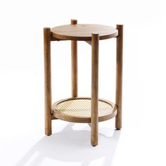 a small wooden table with a wicker basket underneath it on an isolated white background