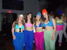 four women in bathing suits standing next to each other on the dance floor at a party