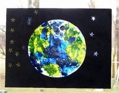 an art project made out of paper with the moon and stars painted on it's side