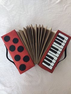 an accordion made to look like a ladybug sitting on top of a sheet