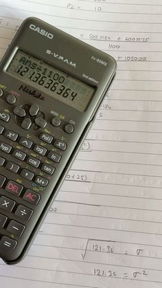 a calculator sitting on top of a piece of paper