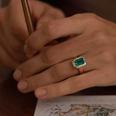 a close up of a person writing on a piece of paper with a pen in their hand