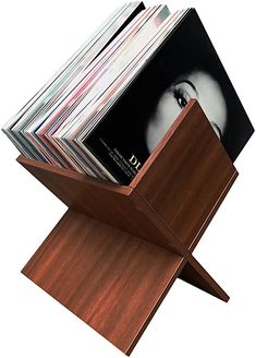 a stack of magazines sitting on top of a wooden stand