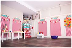 the room is decorated in pink and white with balloons hanging from the ceiling, along with other decorations