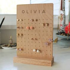 a wooden board with earrings on it