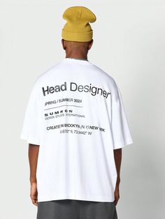 a man with a hat on his head wearing a t - shirt that says head designer