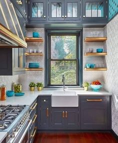 a kitchen with wooden floors and blue cabinets