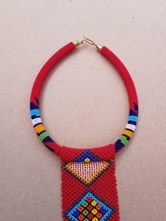 "This necklace is 100% handcrafted using original fine beads. Perfect for African themed events, weddings, traditional events etc. The necklace makes a good gift. Measurements; Rope: 18\" long Pendant: 18\" long. **Buy multiple items and pay shipping for 1 item only.The rest ships free. Custom orders are welcome. More neckleces here; https://www.etsy.com/shop/TribalTess?ref=seller-platform-mcnav&section_id=21306083 Back to my shop; https://www.etsy.com/shop/TribalTess?ref=seller-platform-mcn Pendant Beaded Necklaces For Jewelry Making, Red Beaded Pendant Necklace With Large Beads, Artisan Red Beaded Necklace With Dangling Beads, Unique Red Necklaces With Dangling Beads, Unique Red Necklace With Dangling Beads, Red Pendant Beaded Necklace For Festivals, Red Artisan Beaded Necklaces For Crafting, Artisan Red Beaded Necklaces For Crafting, Gift Pendant Beaded Necklaces With Large Beads