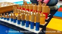 a child is playing with wooden pegs on the floor