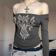 This top marries the raw energy of grunge with avant-garde aesthetics, showcasing a striking bleached cross motif. A true statement piece, its fitted silhouette and eye-catching design make it a bold choice for anyone looking to channel an edgy, artistic vibe. A prime pick for fashion-forward individuals. Grunge aesthetic Bleached design Square neck Long sleeve Also usable off-shoulder Polyester, spandex Grunge Cross, Grunge Jacket, Artistic Vibe, Black Long Sleeve Crop Top, Crop Pullover, Geometric Sleeve, Retro Tops, Aesthetic T Shirts, 90s Streetwear