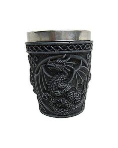 a metal cup with a dragon design on it