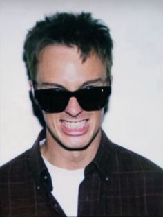 a man wearing sunglasses making a funny face