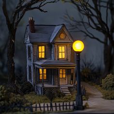 a doll house is lit up in the dark