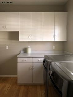 a washer and dryer in a room with white cupboards on the wall