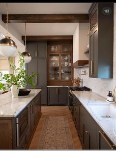 a kitchen with marble counter tops and wooden cabinets, along with an area rug on the floor