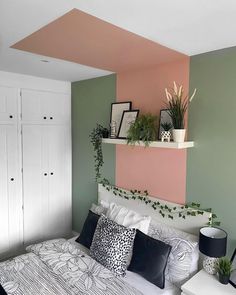 a bedroom with green, pink and white walls