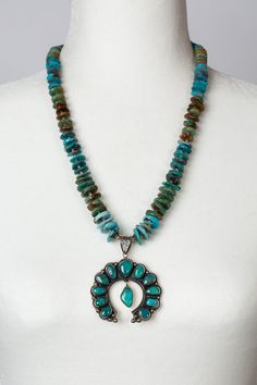 A truly special one of a kind piece, featuring a unique Native American style pendant handcrafted by artist Federico with Turquoise set in sterling silver. Anne Vaughan has paired this pendant with a strand of turquoise and sterling silver spacers. Resting at 22.5-24.5" and finished with lobster claw clasp. Sterling Silver (nickel and lead-safe) Turquoise 22.5-24.5" adjustable with sterling silver lobster claw clasp Turquoise Chrysocolla Necklace With Large Pendant, Artisan Turquoise Necklace With Sterling Silver Clasp, Hand-strung Turquoise Sterling Silver Jewelry, Turquoise Hand-strung Pendant, Hand-strung Turquoise Pendant Jewelry, Hand-strung Turquoise Pendant, Turquoise Sterling Silver Hand-strung Necklace, Hand-strung Turquoise Pendant Necklace, Turquoise Sterling Silver Necklace Hand-strung