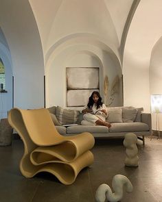 a woman sitting on top of a couch in a living room