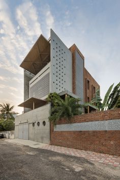 the building is made out of concrete and has a large brick wall on one side