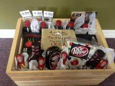 a wooden box with condiments and snacks in it sitting on carpeted floor