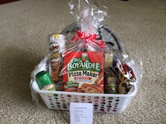 a basket filled with food sitting on top of a carpeted floor next to a sign