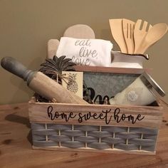 a wooden box filled with kitchen utensils and other items on top of a table