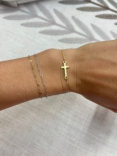 Perfect and dainty gold cross bracelet! Slide the bead to adjust it just where you want it. Adjustable Simple Gold Bracelet, Adjustable Everyday Rosary Bracelet With Cross, Adjustable Cross Rosary Bracelet For Everyday, Spiritual Cross Bracelets For Everyday, Adjustable Everyday Cross Pendant Jewelry, Dainty Adjustable Cross Jewelry, Adjustable Cross Chain Bracelet As Gift, Adjustable Gold Dainty Rosary Bracelet, Gold Dainty Rosary Bracelet