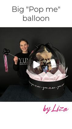 a woman holding an umbrella in front of a ballon with the words big pop me balloon on it