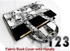 the fabric book cover with handle is made from black and white fabrics, which are handmade