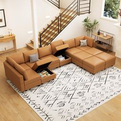 a living room with a sectional couch and stairs