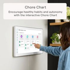 a woman pointing to a large white board with multiple options on it and the text, chore chart encourages healthy habitists and anatomy with the interactive circle chart