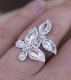 This Fancy sparkling diamond ring is an absolute delight to own and never seem to take off!It showcases two butterfly motifs embellished with pavé-set round and baguette diamonds 1.79 ctw G-H/SI handcrafted from 18K solid white gold.Such an elegant and unique design will draw attention to you!Has Gorgeous Shine,Superior Quality and CraftsmanShip! Butterfly jewelry is one of the most popular design so beloved by women. Butterflies are not only beautiful, but also have mystery, symbolism and meani Luxury White Gold Butterfly Ring, Diamond Butterfly Ring For Wedding, Fine Jewelry Style, Fine Jewelry Diamond Butterfly Ring For Wedding, Wedding Butterfly Diamond Ring Fine Jewelry, Luxury White Gold Butterfly Ring With Cubic Zirconia, Luxury Diamond Butterfly Ring For Formal Occasions, Luxury Diamond Butterfly Ring, Luxury Butterfly Ring For Anniversary, Luxury Butterfly Ring For Wedding