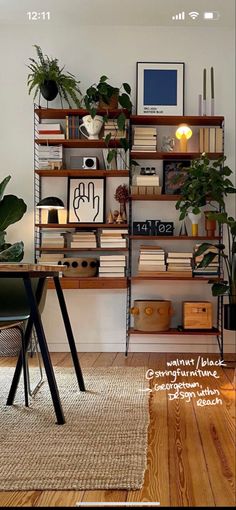 a room with bookshelves and plants on the wall