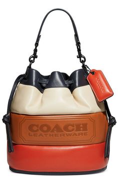 From weekdays to fun-filled weekends, the Field Bucket Bag from COACH includes a lightweight strap to wear as a crossbody. 8-3/4"W x 9-3/4"H x 5-1/2"D (width is measured across the bottom of handbag) Silhouette is based off 5'9" model 5-3/4"L handle; 24-1/2"L detachable crossbody strap Drawstring closure Exterior hangtag, protective feet Interior zip pocket Leather Wipe clean Includes dust bag  Brand new in original packaging Coach 1941, Webbing Strap, Leather Bucket Bag, Leather Bucket, Bago, Embossed Leather, Smooth Leather, Coach Bags, Camera Bag