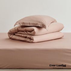 the sheets and pillow cases are folded on top of each other