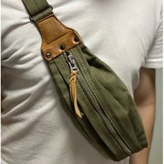 a man wearing a green fanny bag with two zippers on the front and one in the back