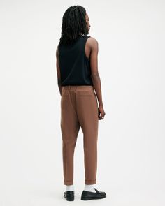 Traditional tailoring, modernized. The Tallis Pants are crafted from a conscious cotton-wool blend fabric with a slim, tapered leg – finished with a cropped ankle, multiple pockets and front pleats. They've got an ease to them that gives you endless styling options.  These pants are designed to a slim fit Tapered leg Mid-rise Cropped tapered fit Subtle pleat detailing from the waistband Brown Tapered Leg Chinos For Work, Allsaints Relaxed Fit Cotton Bottoms, Fall Tapered High-waisted Chinos, Fall High-waisted Tapered Chinos, Allsaints Relaxed Fit Straight Leg Bottoms, Allsaints Straight Leg Relaxed Fit Bottoms, Allsaints Straight Leg Bottoms Relaxed Fit, Allsaints Relaxed Fit Bottoms For Spring, Tapered Ankle-length Chinos With Belt Loops