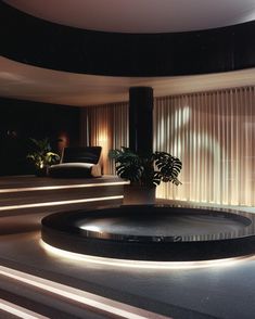 a circular room with lights and plants in it