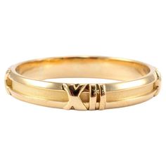 Brand: Tiffany & Co. Gender: Men Metal Type: 18K Yellow Gold Ring Size: 12 Width: 4.20 mm Weight: 4.70 grams Men's 18K Yellow Gold wedding band with a comfort-fit shank. The metal was tested and determined to be 18K yellow gold. Engraved with "750". The "Tiffany & Co." trademark (or hallmark) can also be found on the item. In excellent condition. Pre-owned. Might show minor signs of wear. SKU: 188616 Yellow Gold Wedding Band, 18k Yellow Gold Ring, Tiffany And Co, Yellow Gold Ring, Gold Wedding Band, Roman Numerals, Yellow Gold Rings, Gold Wedding, Tiffany & Co.