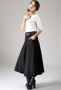 "Update your smart casual wardrobe with this black wool skirt. Classic in style with a modern twist, this pleated skirt will soon become your favorite. Handmade in beautiful soft wool and fully lined, this long skirt will be your staple this winter. Team the women's skirt with a crisp white blouse, some ankle boots and other accessories for an instantly classic look for any occasion. The woman skirt features a pleated front and back and has two pockets. DETAILS: * wool blend * polyester lining * Black A-line Pleated Skirt For Office, Elegant Flared Skirt With Pockets, Chic Black Skirt With Box Pleat, Elegant Black Skirt With Box Pleat, Elegant Black Box Pleat Skirt, Black Box Pleat Pleated Skirt For Work, Black A-line Skirt With Pleated Waist, Black A-line Skirt With Pleated Hem, Chic Black Pleated Skirt With Pockets