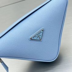 SHOP MORE LUXURY PRODUCTS HERE Description Prada Triangle Mini Bag Blue For Women, Women’s Bags 9.8in/25cm Introduced for the first time on trunks designed by Mario Prada, the Prada triangle expresses uniqueness and modernity through its minimalist and universal silhouette, reinvented in a different way every season. Its geometric shape inspires this mini bag with a modernist and modular design that lets it be worn in a variety of ways: the two triangles that compose it can be separated an Luxury Blue Bag With Zipper Pocket, Blue Pouch Bag For Business, Classic Blue Pouch Bag, Blue Business Pouch Bag, Business Blue Pouch Bag, Prada Triangle, Louis Vuitton Shirt, Triangle Bag, Fabric Handbags