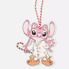 a cartoon character ornament hanging from a red and white striped cord on a white background