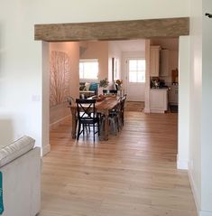 a living room and dining area with hardwood floors in the middle, an open floor plan is shown on the wall