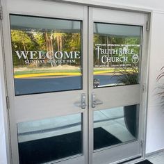 two glass doors with the words welcome and truth bible church on them