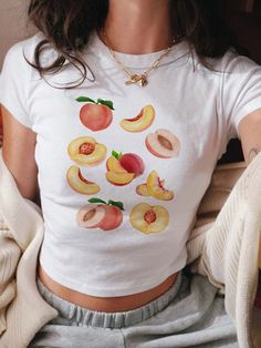 Peaches Baby Tee, Fruit Shirt, Peach Shirt, Vintage Fruit Tee, Peach Graphic T-Shirt, Aesthetic Fruit Shirt, Gift For Women *IMPORTANT PLEASE READ BEFORE PURCHASING* My store uses DTG (Direct to Garment) printing. This means the design is printed into the garment. This means it is designed to last longer than other printing processes. Due to this printing process the design colors may not be as vibrant as shown in the photos. There may at times be a slight difference between real and perceived c Fruit Print Fashion, Fruit Outfit, Fruit T Shirt, Fruit Clothes, June Fashion, Peach Outfit, Fruit Clothing, Peach Clothes, Aesthetic Fruit