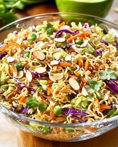 a glass bowl filled with noodles and vegetables