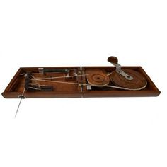 a wooden tray with various types of musical instruments on it and strings attached to the sides