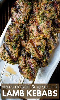 grilled herb crusted lamb kebabs on a white platter with text overlay