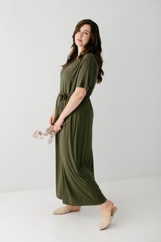 Simple and elegant, the 'Kate' features a modest v-shaped neckline with a button detail. Short sleeves and a belted waist add a finishing touch to this timeless maxi dress. The soft knit and functional buttons make this an ideal pick for expecting and nursing mamas. The option of minimal layering makes the 'Kate' an easy choice for everyday comfort. All you'll need to decide is what shoes to wear! Exclusively designed by us for you. 95% Rayon 5% Spandex Hand Wash Cold Hang or Lay Flat to Dry Low Maternity Maxi Dress In Solid Color, Casual Solid Maxi Dress With Tie Waist, Fall Maternity Maxi Dress, Modest Maternity Midi Dress, Maxi Dress With Tie Waist, Modest Maxi Dress With Elastic Waistband, Modest Midi Dress With Tie Waist, Casual Maxi Dress With Tie Waist, Belted Maxi Dress For Daywear